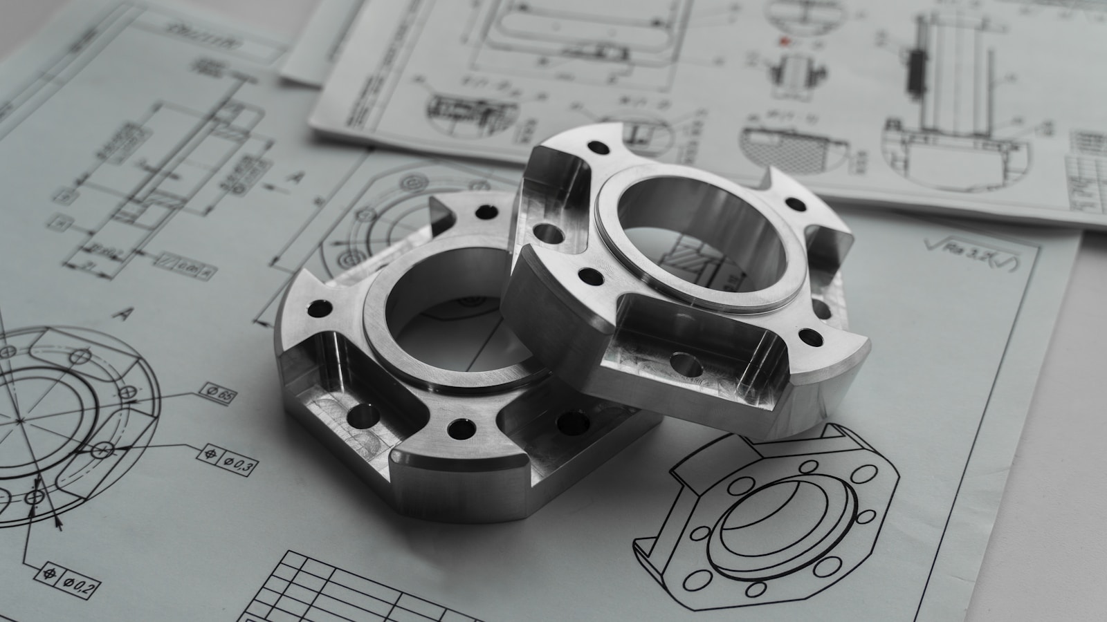 Precision mechanical parts on engineering blueprints